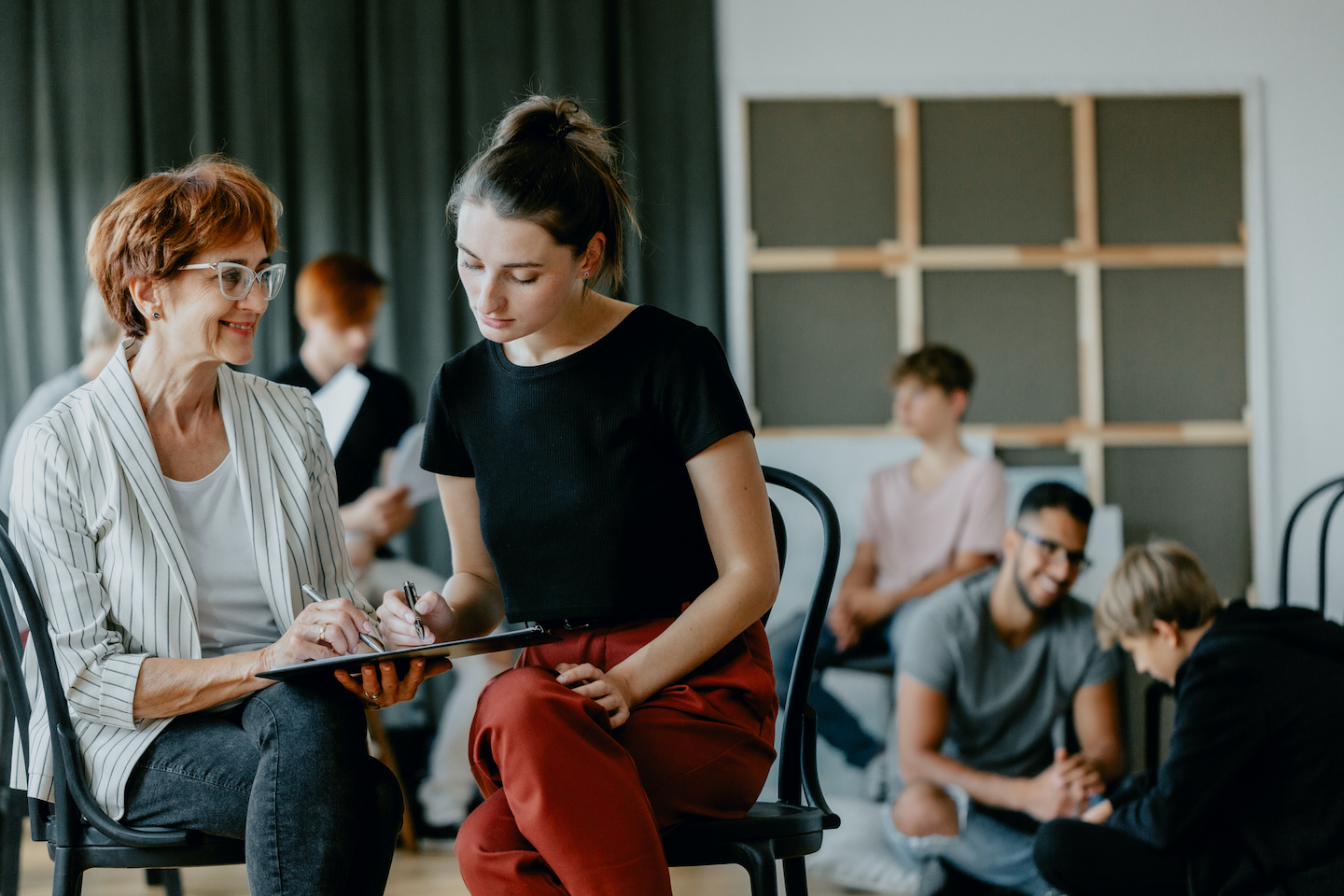 Young girl and psychologist talking about the results of group psychotherapy